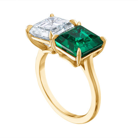 Three quarter view of the Emerald and Diamond Toi et Moi Ring, showcasing a 3.5 carat Colombian emerald paired with a 3.5 carat D color VS1 diamond, in a handmade 18 karat yellow gold setting