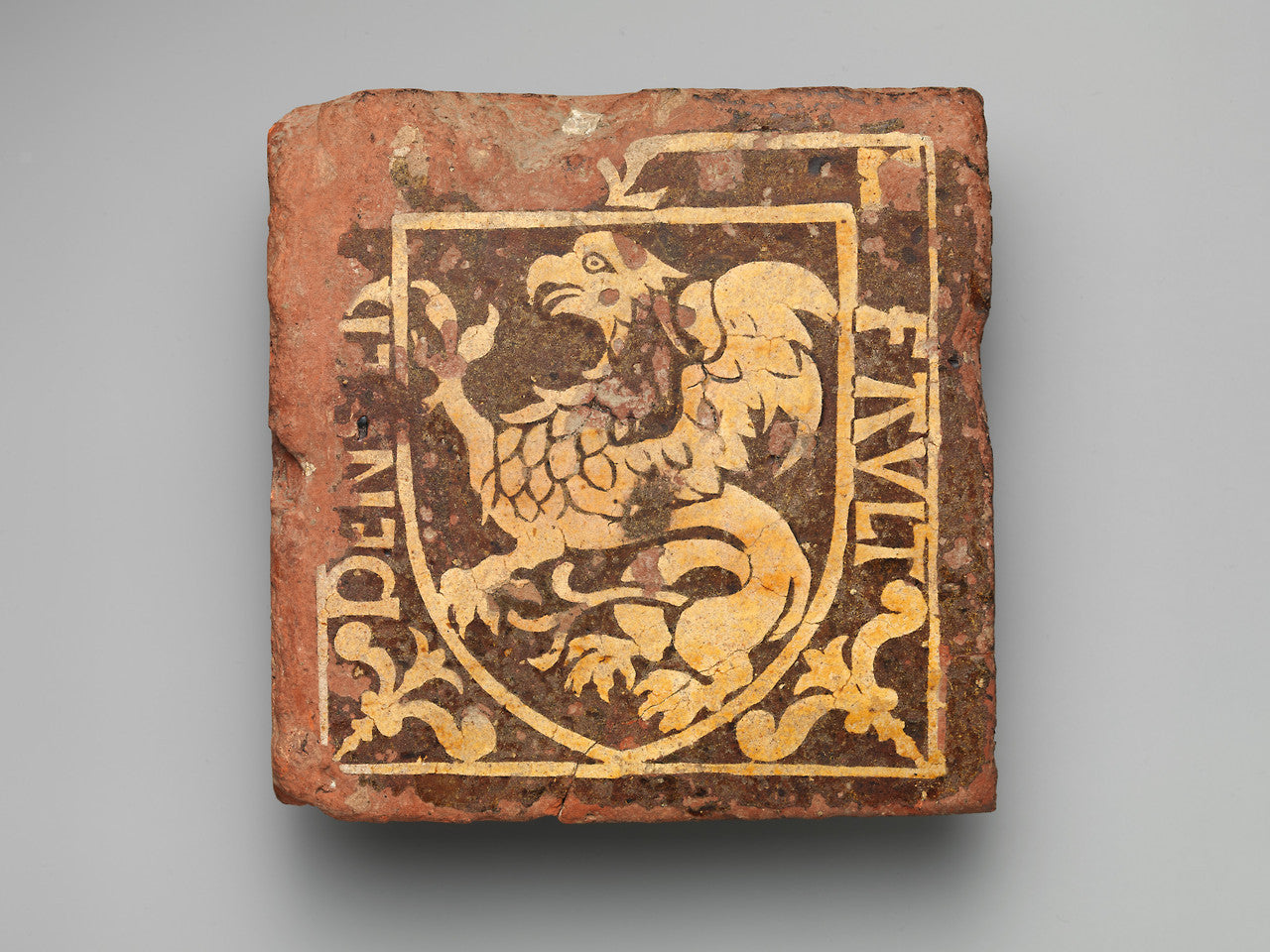 Images of an acient tile that depicts and eraly redition of a Griffen, the logo for Susan Kottemann, a fine jeweler in NYC.